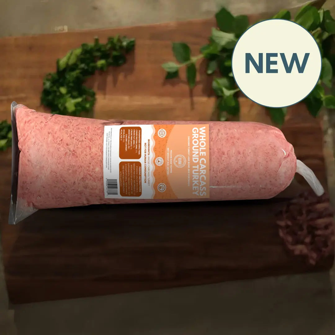 Package of ground turkey with a 'NEW' label on a wooden surface