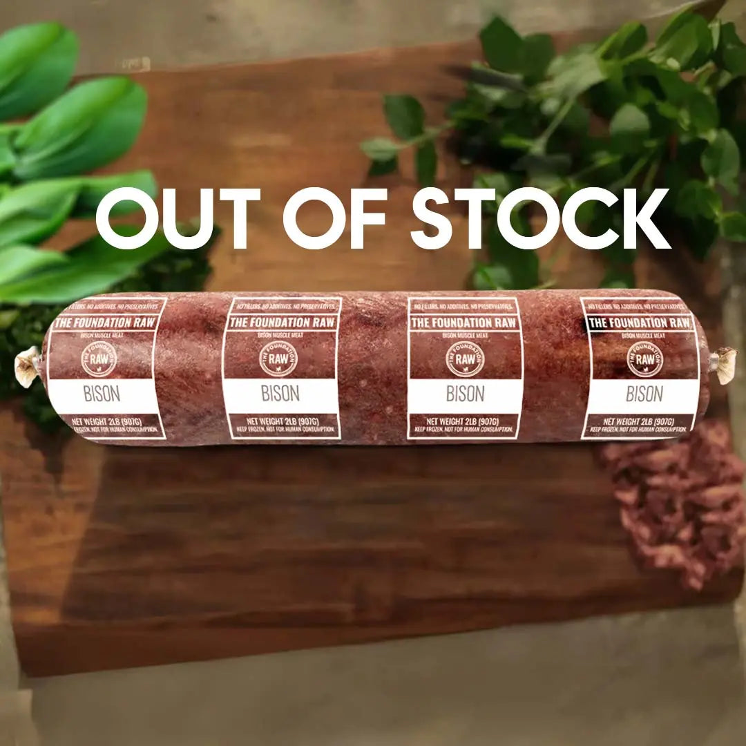 Rolled bison meat with labels on a wooden board, surrounded by green plants, with 'Out of Stock' text overlay.