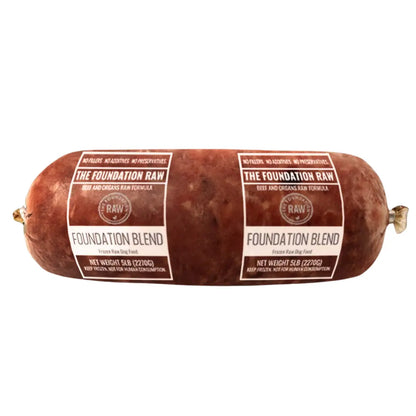 Rolled meat dog food with transparent plastic packaging labeled "The Foundation Raw, Foundation Blend" 