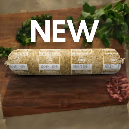 Rolled meat product with 'NEW' text on a wooden surface