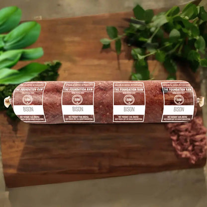 Ground bison in a chopping board with leaves 