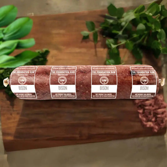 Ground bison in a chopping board with leaves 