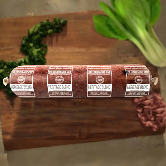 Rolled meat  heritage blend 'The Foundation Raw' label on a wooden cutting board. heritage blend raw beef dog food beef muscle meat beef heart green tripe beef liver beef kidney beef spleen raw food diet for dogs raw dog food raw dog food roll
